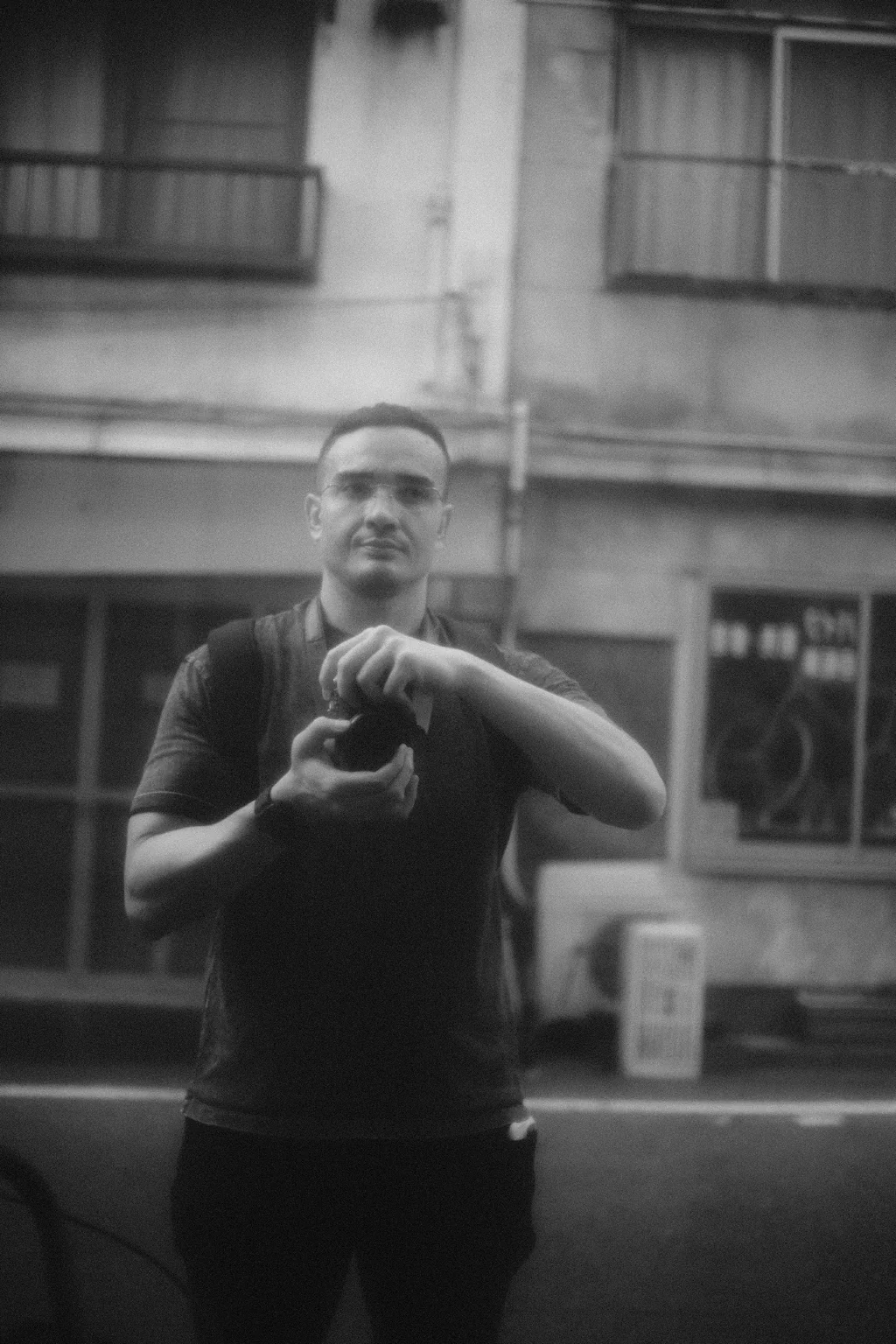 Ron Wilburn holding a camera in a black and white reflection